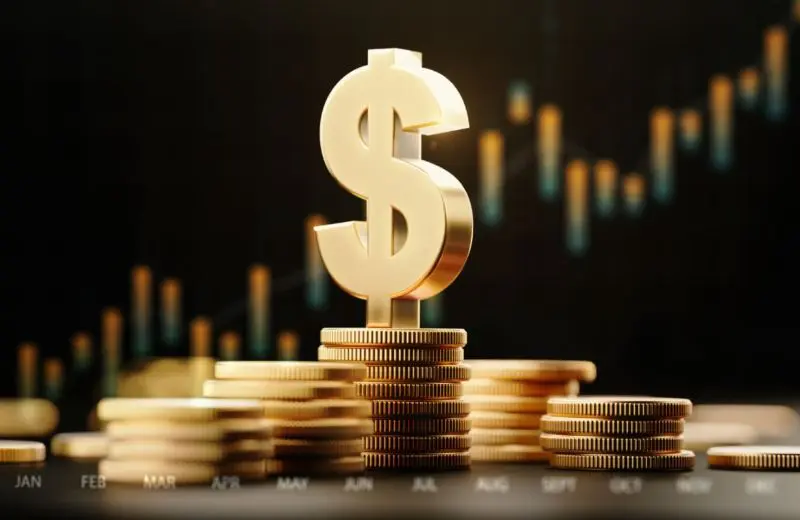 Stacked gold coins with a large golden dollar sign symbol on top.